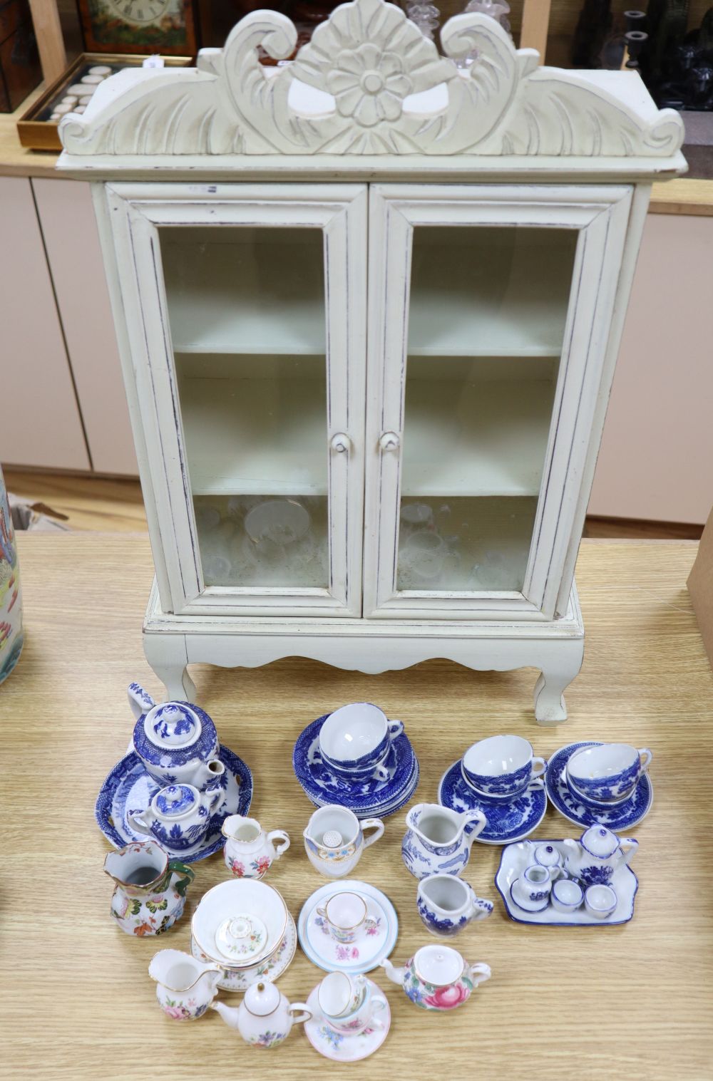 A collection of Victorian Staffordshire childrens blue and white tea ware, in a miniature armoire, height 59cm